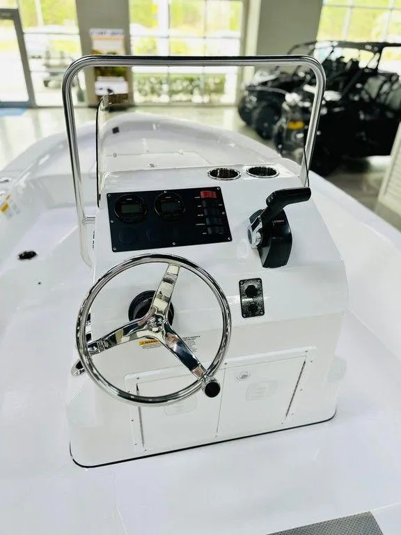 Slide: The Image of 2025 Frontier 180 boat console with steering wheel and controls in showroom. - 8