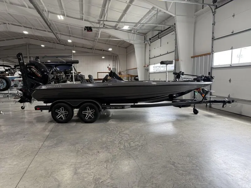 Slide: The Image of 2025 Skeeter ZXR20 boat in a spacious indoor showroom. - 1