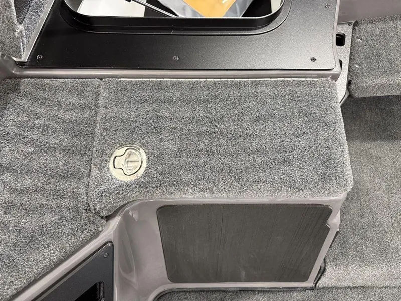 Slide: The Image of 2025 Skeeter ZXR20 boat interior with gray carpet and storage compartment. - 10