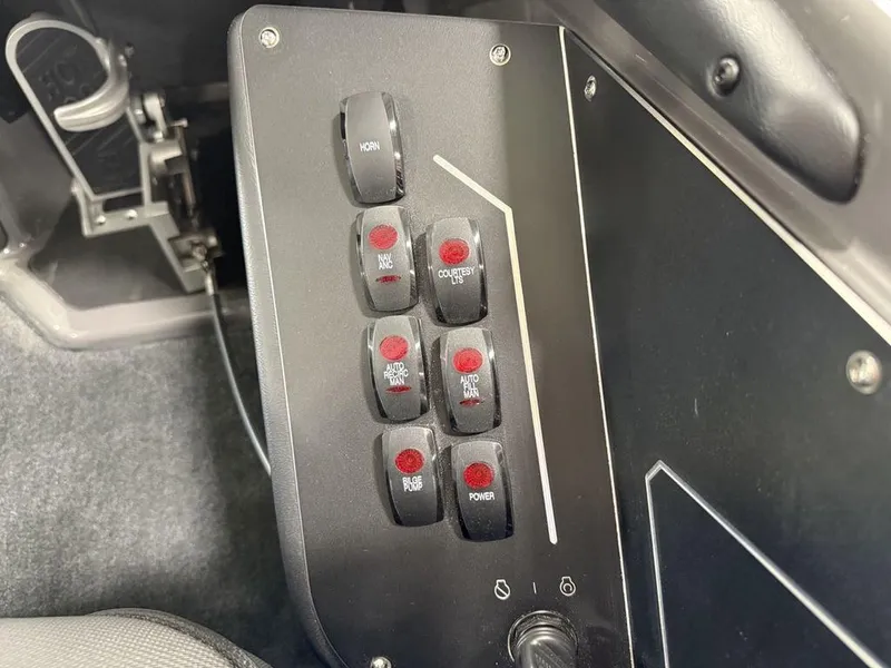 Slide: The Image of Control panel of 2025 Skeeter ZXR20 boat with various switches and buttons. - 16