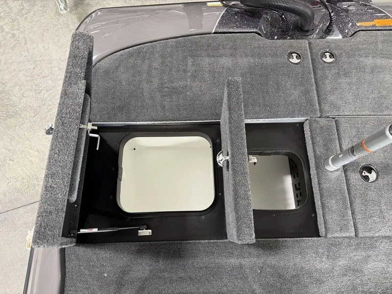 Slide: The Image of Open storage compartments on a 2025 Skeeter ZXR20 boat deck. - 18