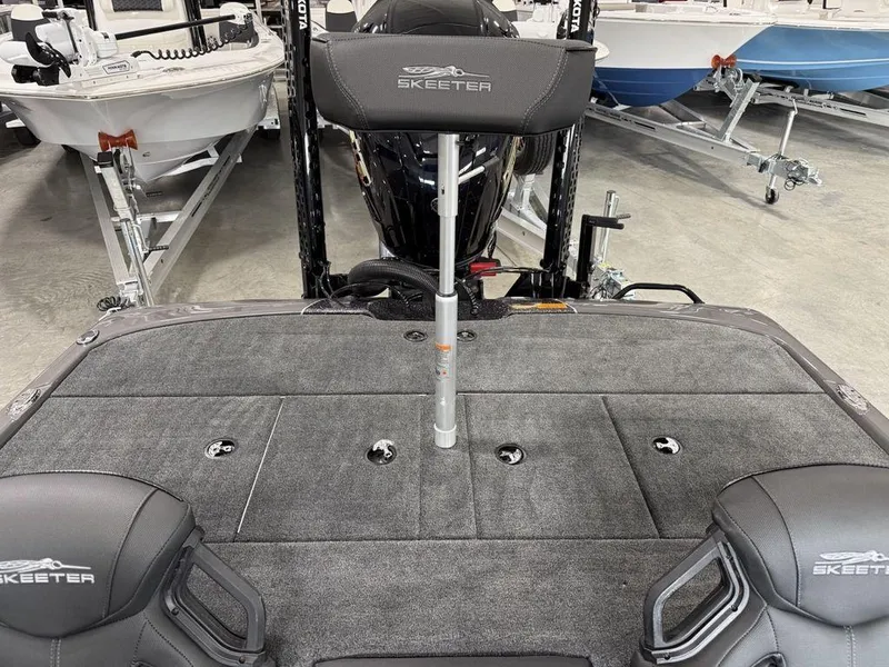 Slide: The Image of 2025 Skeeter ZXR20 boat interior with gray carpet and branded seating. - 20