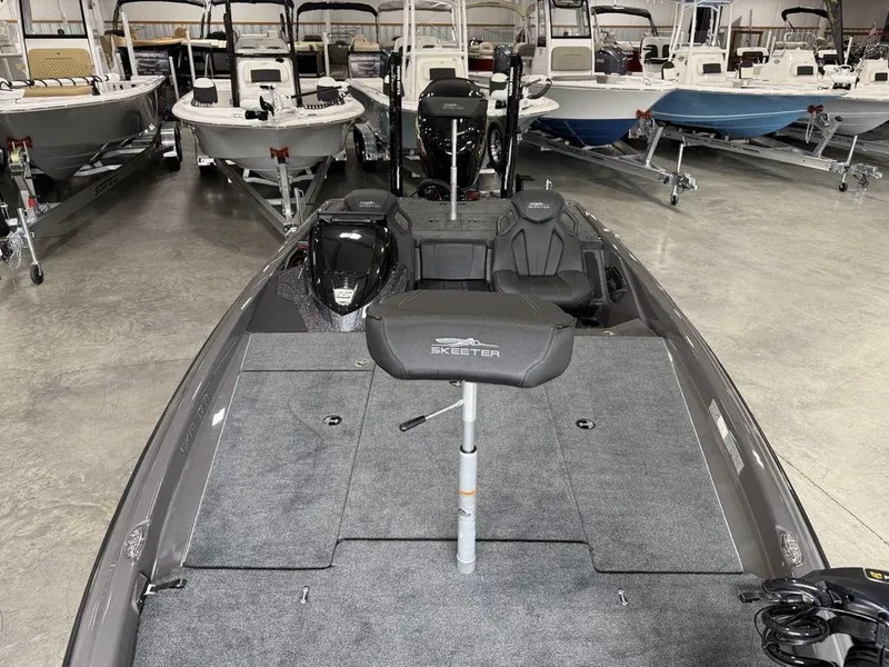 Slide: The Image of 2025 Skeeter ZXR20 boat in showroom, surrounded by other boats. - 23