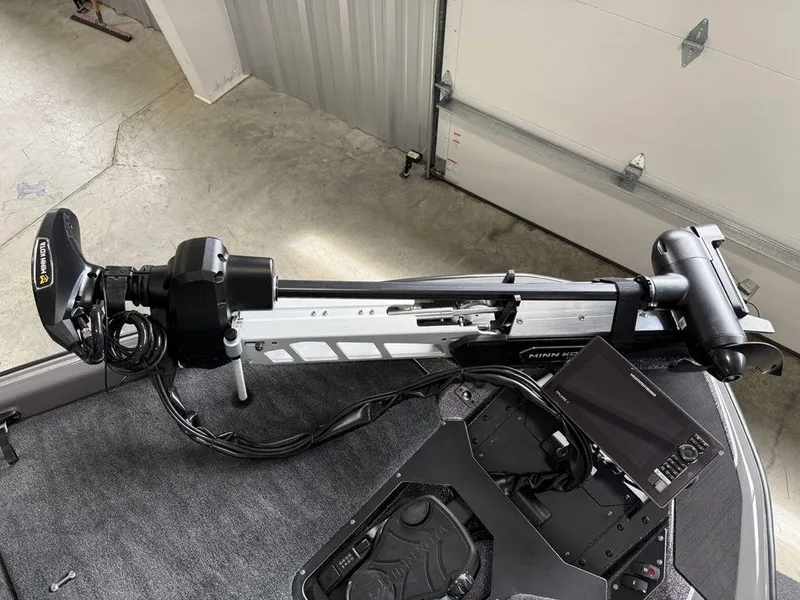 Slide: The Image of 2025 Skeeter ZXR20 boat with Minn Kota trolling motor in a garage setting. - 4
