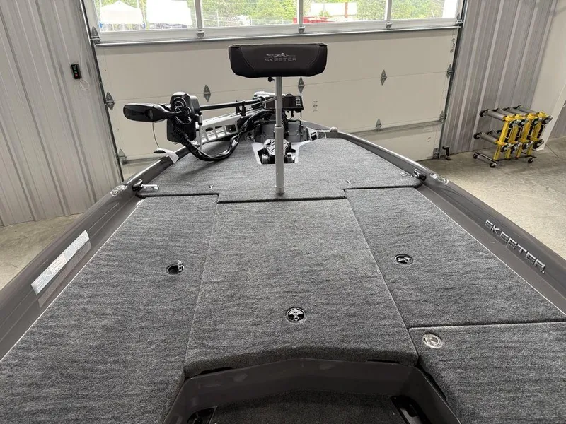 Slide: The Image of 2025 Skeeter ZXR20 boat interior with gray carpet and mounted equipment. - 7
