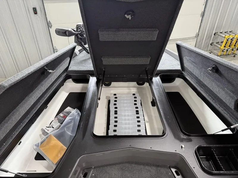 Slide: The Image of 2025 Skeeter ZXR20 boat storage compartments open in a garage setting. - 9