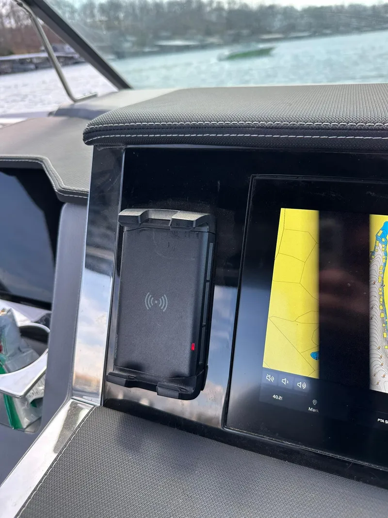 Slide: The Image of Dashboard of 2023 Cobalt R33 boat with navigation screen and phone holder. - 10