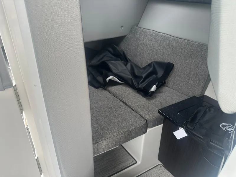 Slide: The Image of 2023 Cobalt R33 interior cabin with gray seating and black fabric. - 17