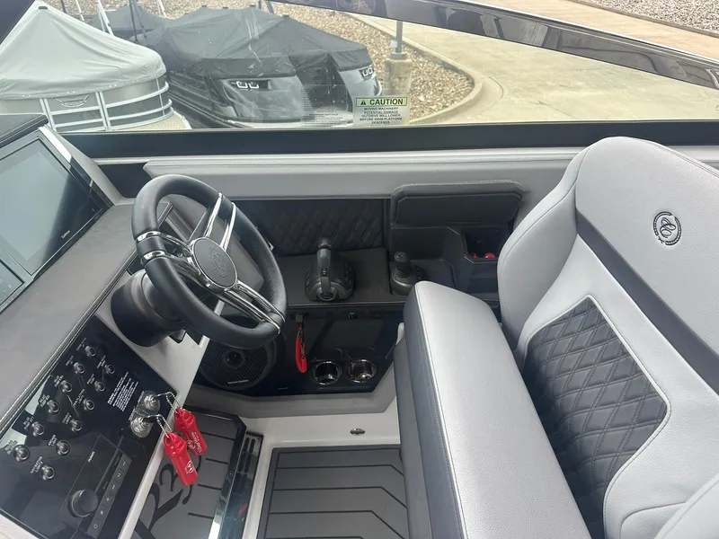 Slide: The Image of Interior of a 2023 Cobalt R33 boat, featuring a sleek steering wheel and modern dashboard. - 19