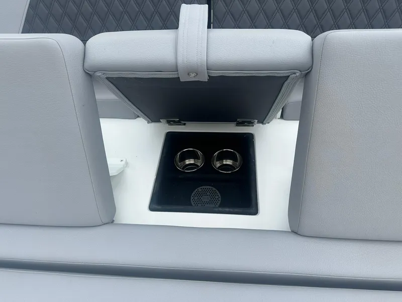 Slide: The Image of 2023 Cobalt R33 boat interior with cup holders and gray seating. - 24
