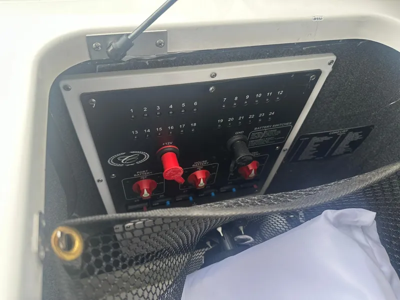 Slide: The Image of Control panel of a 2023 Cobalt R33 boat with switches and wiring. - 27