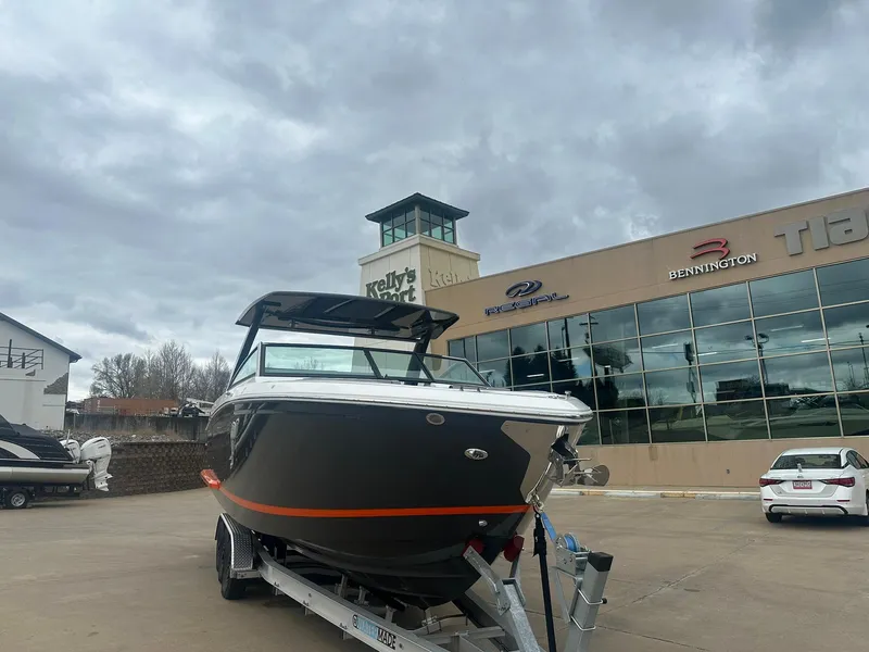 Slide: The Image of 2023 Cobalt R33 boat on trailer outside dealership under cloudy sky. - 3