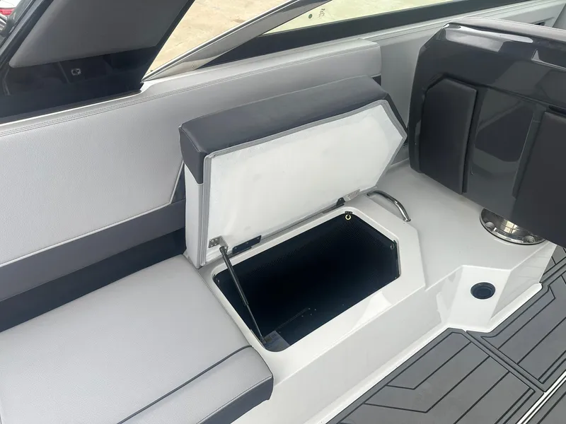 Slide: The Image of 2023 Cobalt R33 boat interior with open storage compartment and sleek seating design. - 30