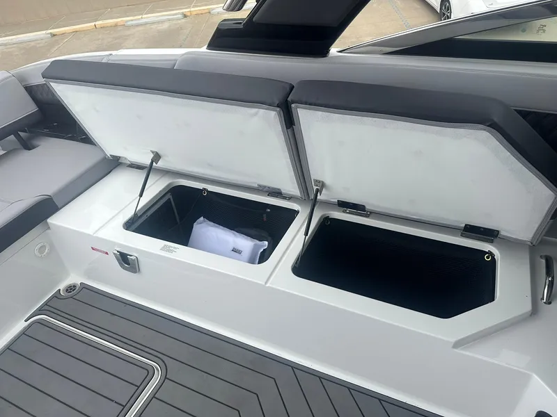 Slide: The Image of 2023 Cobalt R33 boat with open storage compartments on deck. - 31