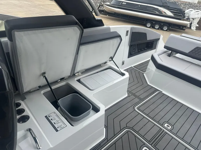 Slide: The Image of 2023 Cobalt R33 boat interior with open storage compartments and sleek seating design. - 32