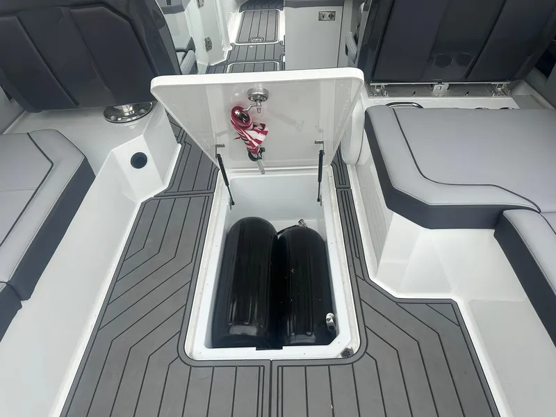 Slide: The Image of 2023 Cobalt R33 boat interior with open storage compartment and seating. - 34