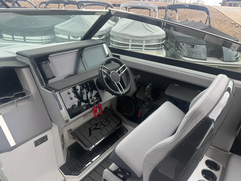 Slide: The Image of 2023 Cobalt R33 boat cockpit with modern dashboard and steering wheel. - 41