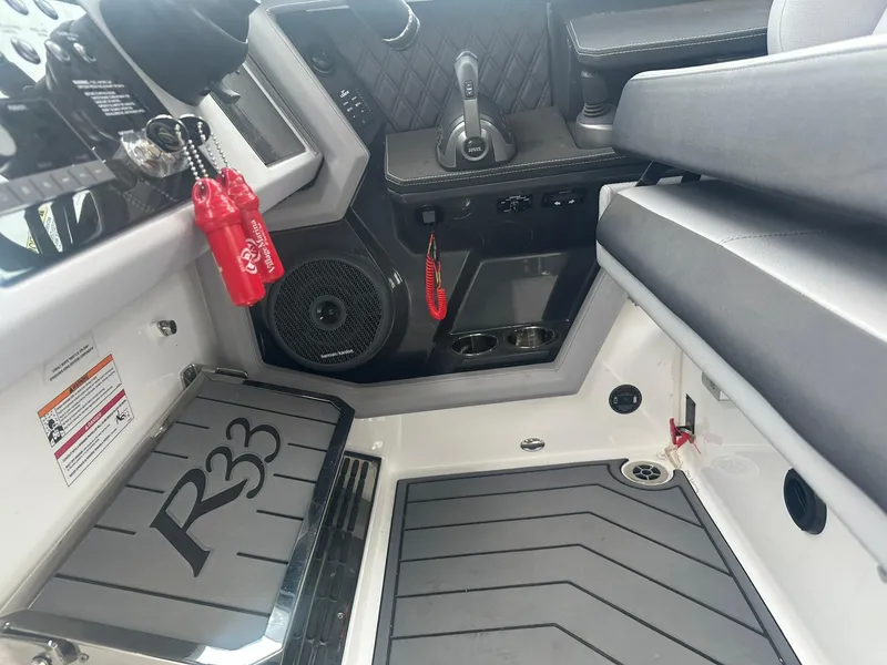 Slide: The Image of 2023 Cobalt R33 boat interior with modern controls and seating. - 47