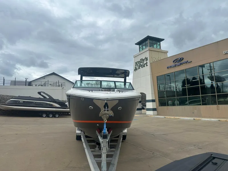 Slide: The Image of 2023 Cobalt R33 boat on trailer at dealership, cloudy sky background. - 5
