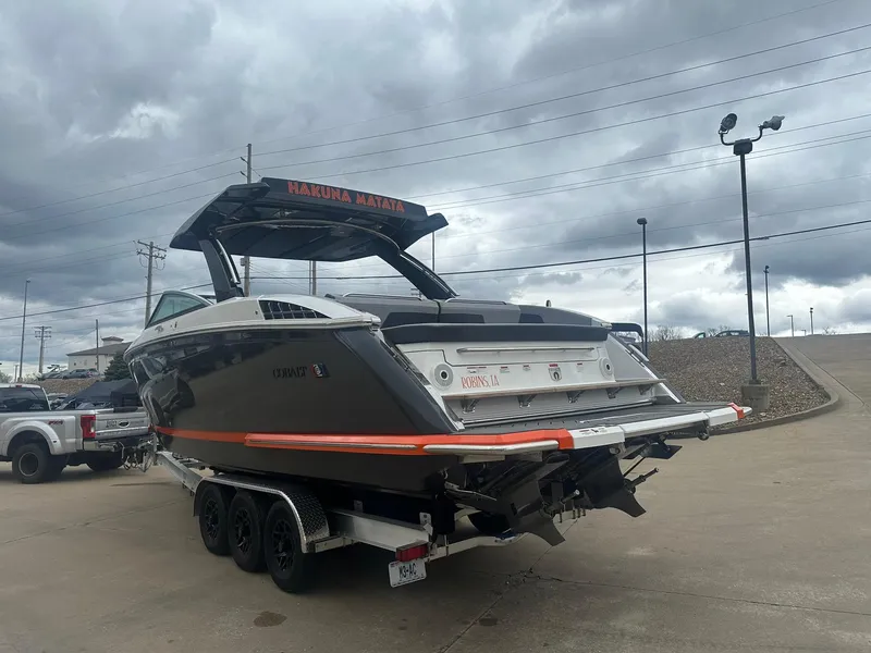 Slide: The Image of 2023 Cobalt R33 boat on trailer under cloudy sky at marina. - 7