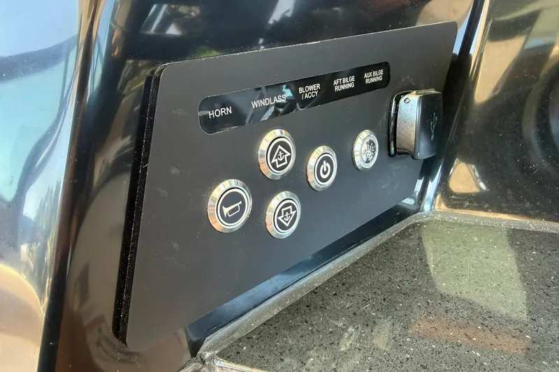 Slide: The Image of Control panel of 2026 Monterey Elite 30 OB boat with various switches and buttons. - 13