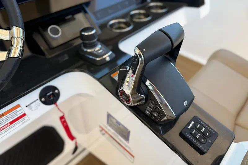 Slide: The Image of 2026 Monterey Elite 30 OB boat control panel with steering wheel and throttle. - 15