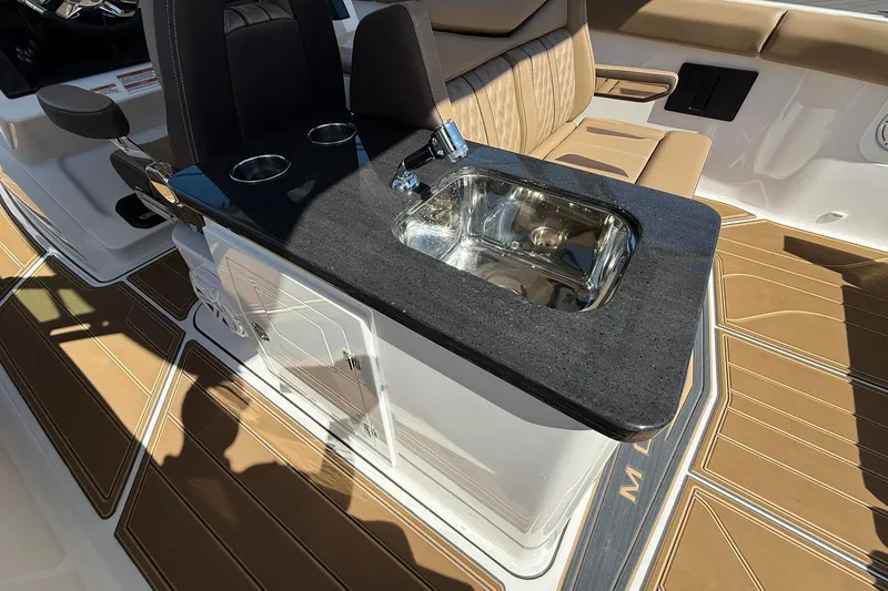 Slide: The Image of 2026 Monterey Elite 30 OB boat interior with sink and seating area. - 18