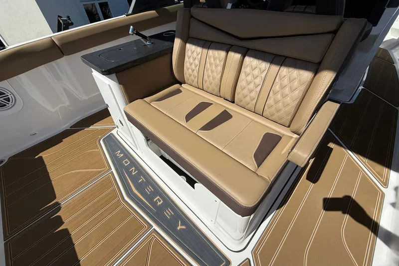 Slide: The Image of Luxurious seating on 2026 Monterey Elite 30 OB boat with elegant brown upholstery. - 19
