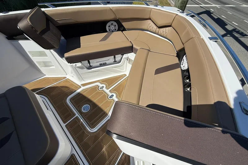 Slide: The Image of Luxurious seating area on 2026 Monterey Elite 30 OB boat with brown cushions and wood-style flooring. - 3