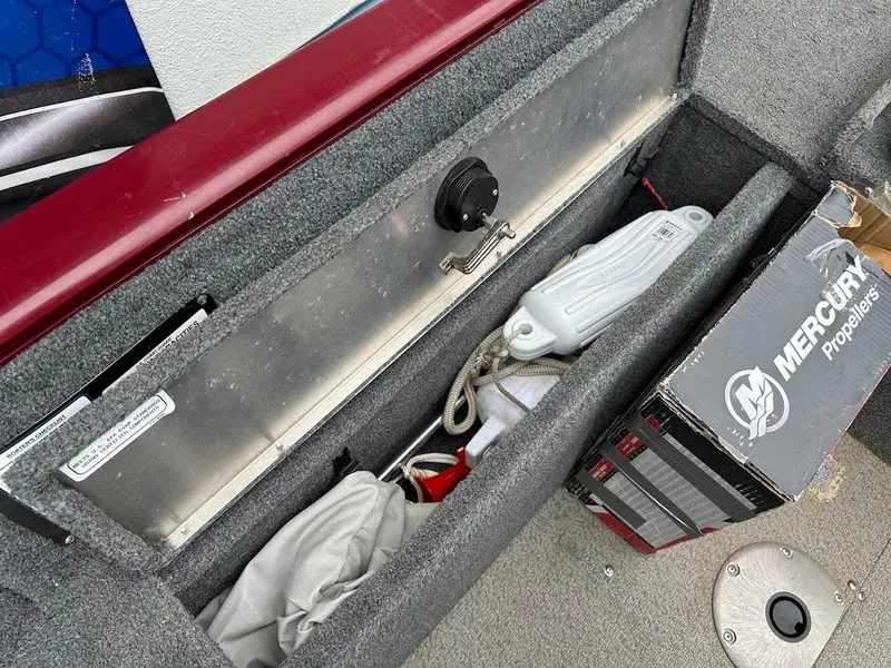 Slide: The Image of Storage compartment in a 2018 Tracker Pro Guide V-175 Combo boat with Mercury propeller box. - 24