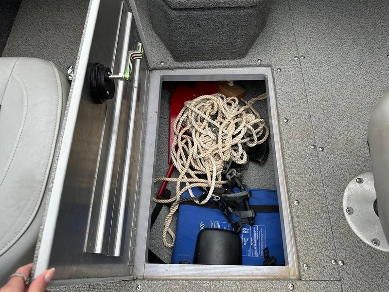 Slide: The Image of Storage compartment in 2018 Tracker Pro Guide V-175 Combo boat with rope and equipment. - 25