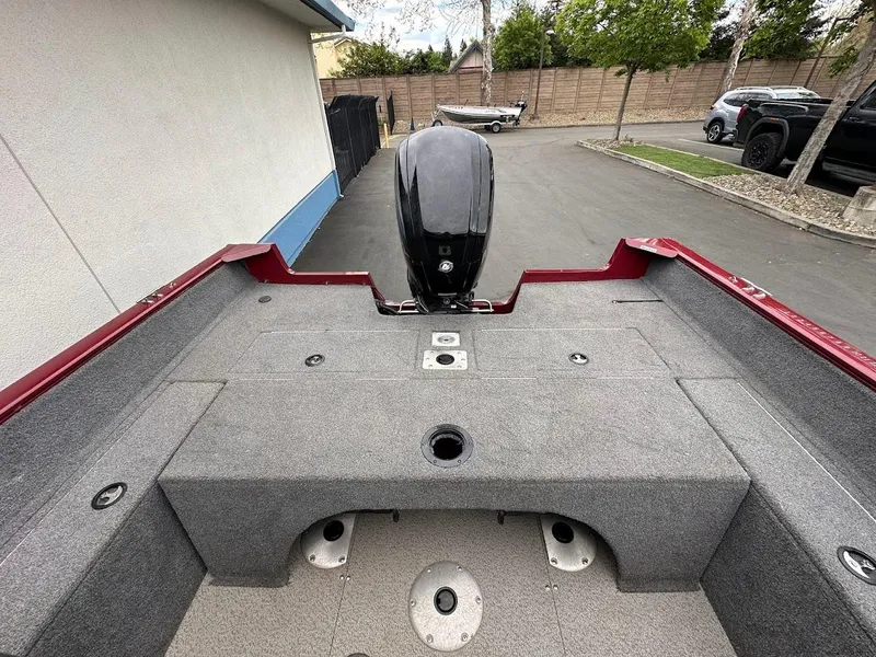 Slide: The Image of 2018 Tracker Pro Guide V-175 Combo boat interior with motor, parked outdoors. - 26