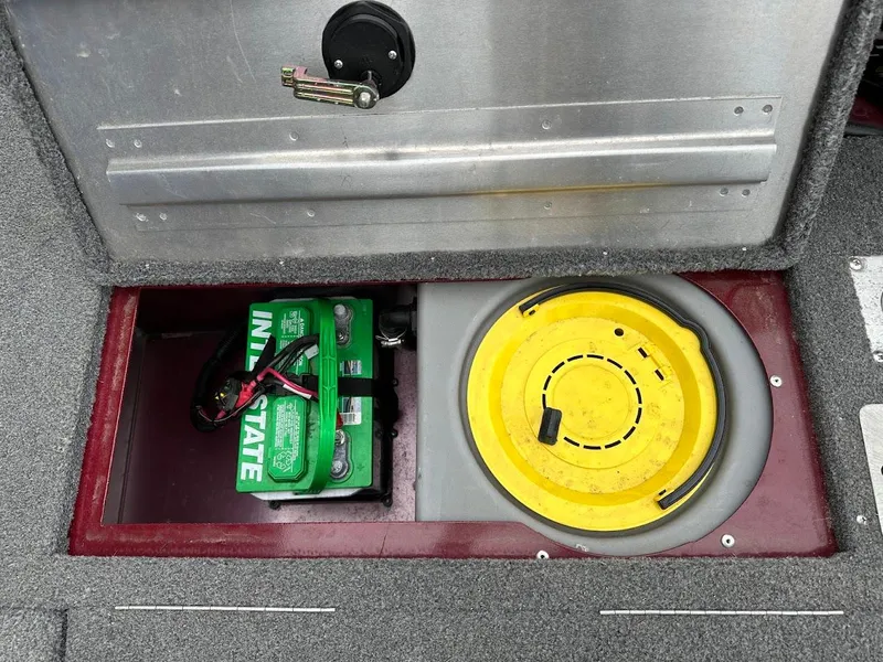 Slide: The Image of 2018 Tracker Pro Guide V-175 Combo battery compartment with Interstate battery and yellow storage lid. - 29