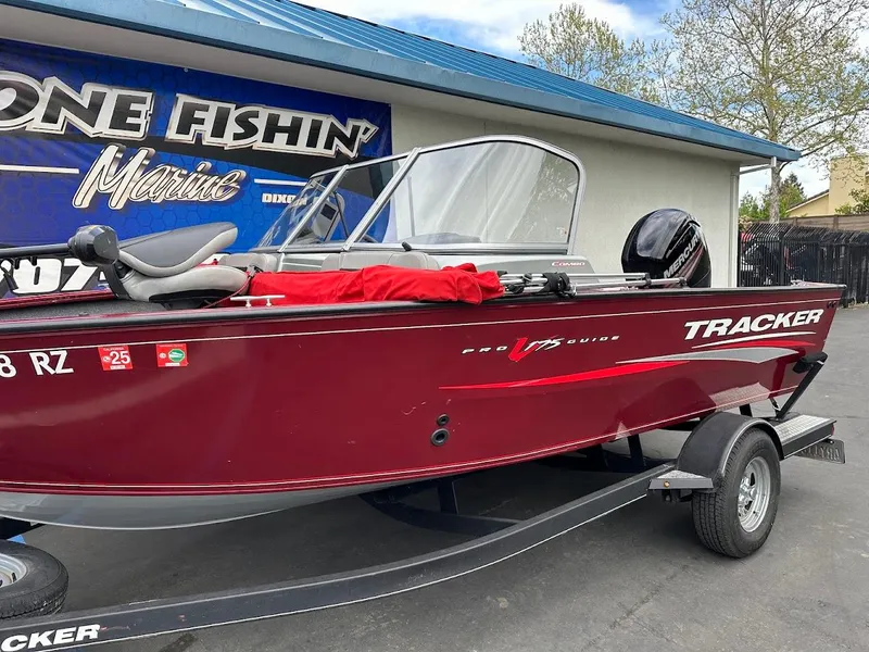 Slide: The Image of 2018 Tracker Pro Guide V-175 Combo boat in red, parked on a trailer. - 5