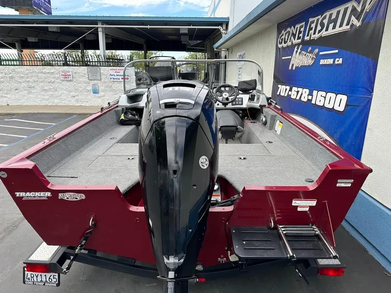 Slide: The Image of 2018 Tracker Pro Guide V-175 Combo boat, red exterior, parked at dealership. - 9
