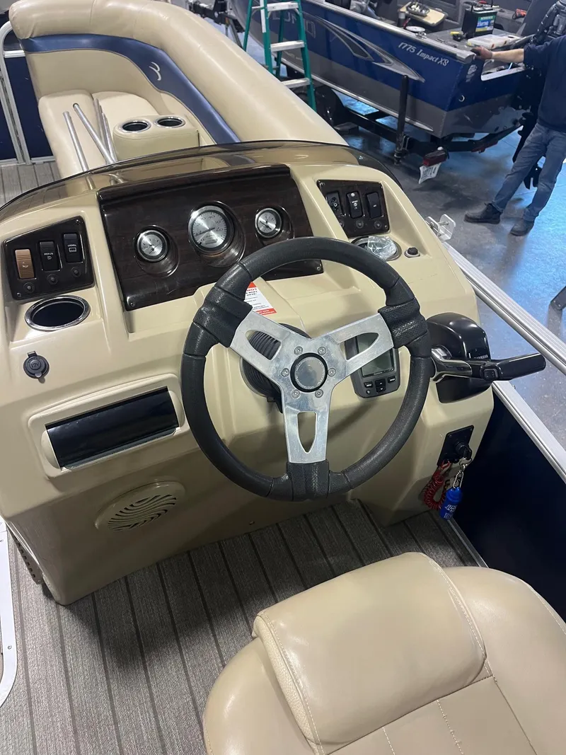 Slide: The Image of 2014 Bennington 22 SSLX boat dashboard with steering wheel and control panel. - 4