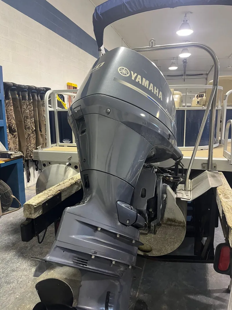 Slide: The Image of 2014 Bennington 22 SSLX with Yamaha outboard motor in a garage setting. - 7