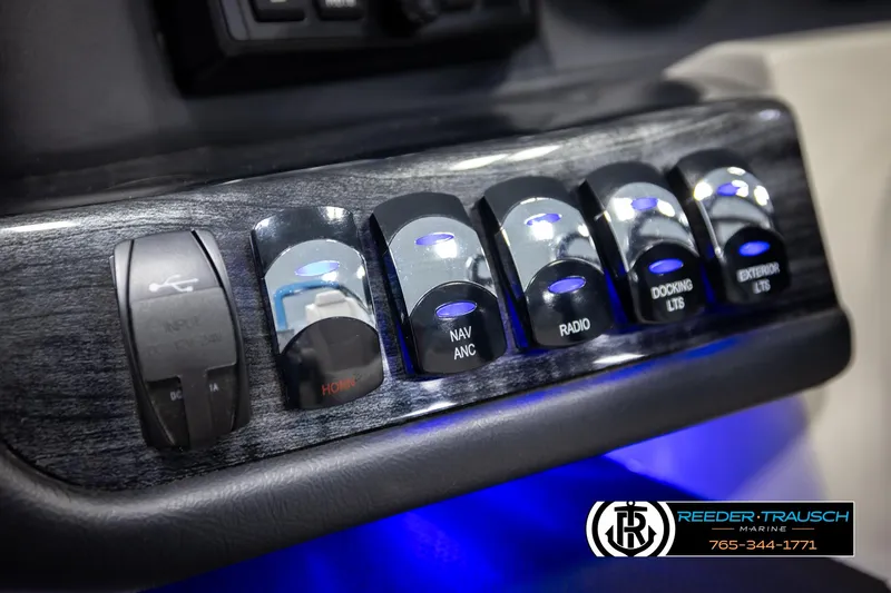 Slide: The Image of Control panel of 2020 Avalon 2385 CAT EL with illuminated switches and blue LED lighting. - 27
