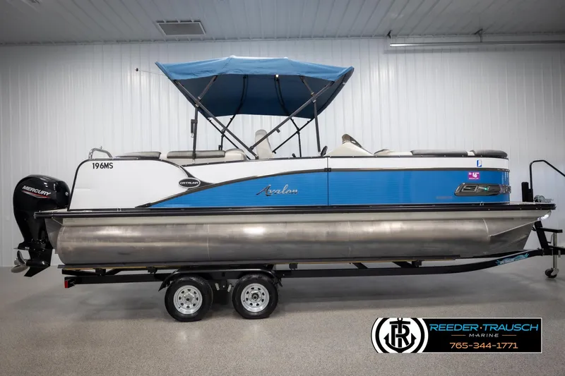 Slide: The Image of 2020 Avalon 2385 CAT EL pontoon boat with blue canopy on trailer in showroom. - 5