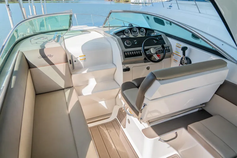 Slide: The Image of 2014 Sea Ray 260 Sundancer boat interior with helm, seating, and dashboard. - 11