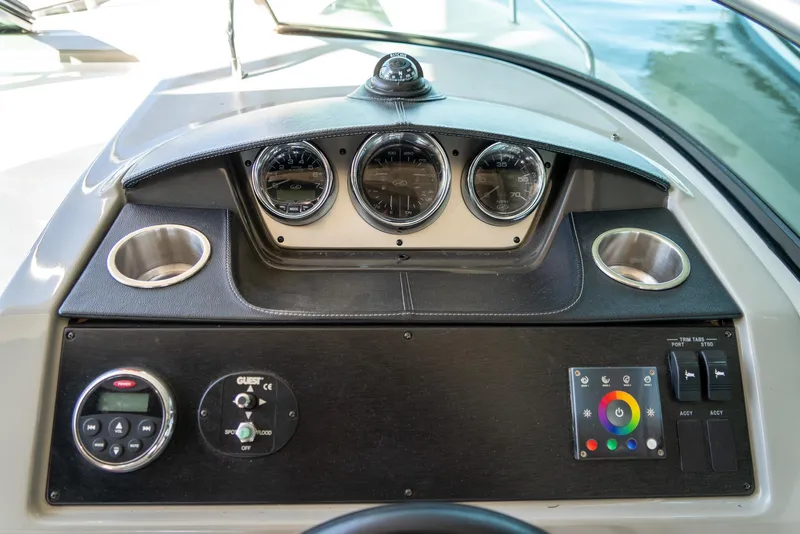 Slide: The Image of Dashboard of 2014 Sea Ray 260 Sundancer boat with gauges and controls. - 14