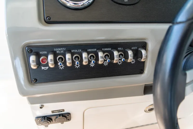 Slide: The Image of Control panel of a 2014 Sea Ray 260 Sundancer boat with labeled switches. - 15