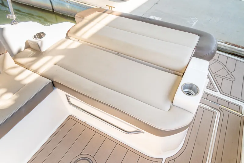 Slide: The Image of 2014 Sea Ray 260 Sundancer boat interior with beige seating and cup holders. - 20