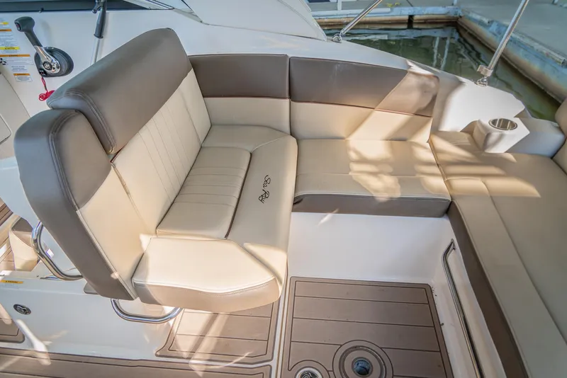 Slide: The Image of 2014 Sea Ray 260 Sundancer boat interior with beige and brown seating. - 21