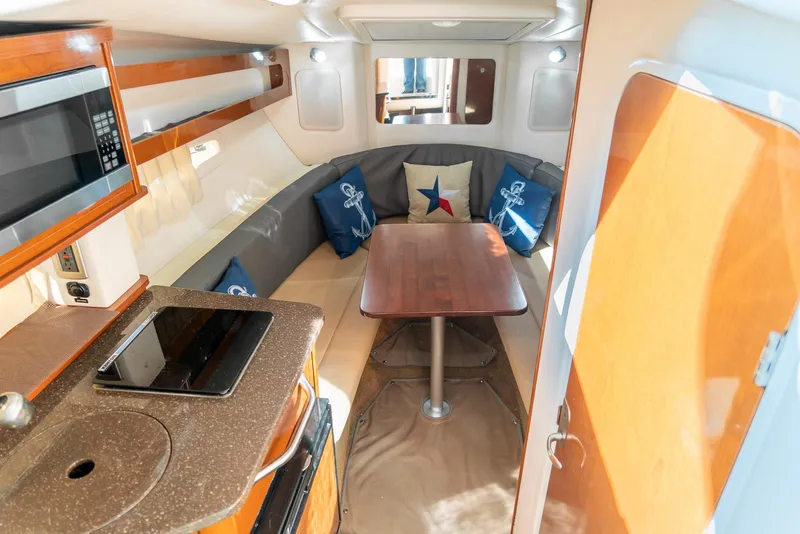 Slide: The Image of Interior of 2014 Sea Ray 260 Sundancer with kitchenette and cozy seating area. - 22