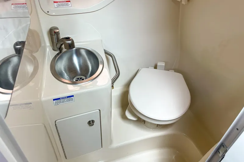 Slide: The Image of Compact bathroom in 2014 Sea Ray 260 Sundancer with sink and toilet. - 35