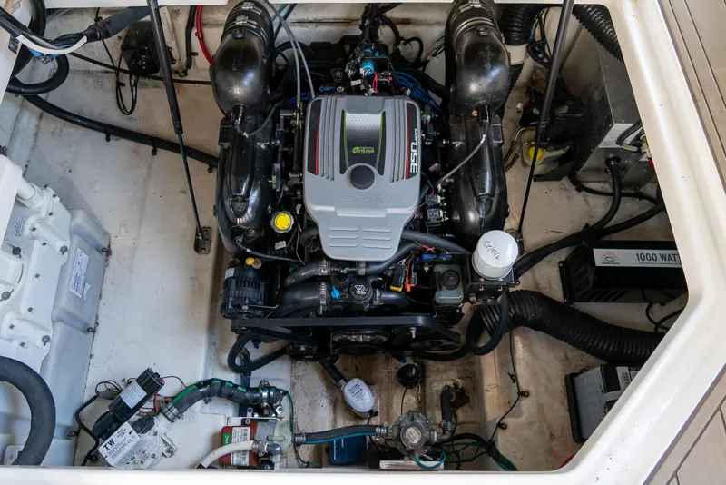 Slide: The Image of Engine compartment of a 2014 Sea Ray 260 Sundancer boat, showcasing detailed mechanical components. - 36