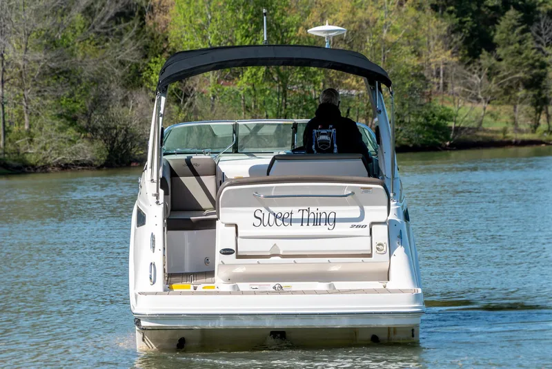 Slide: The Image of 2014 Sea Ray 260 Sundancer boat on a calm lake, rear view. - 6