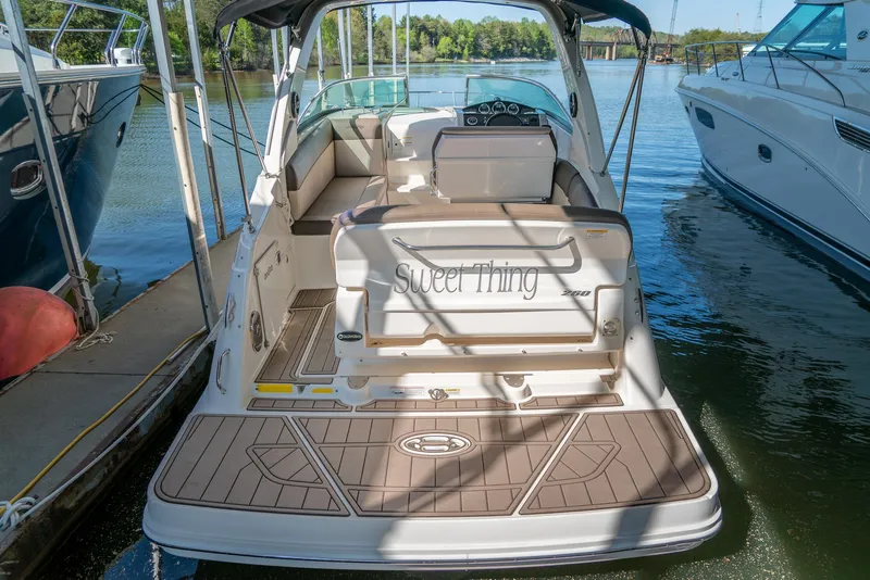 Slide: The Image of 2014 Sea Ray 260 Sundancer boat docked, rear view with seating and swim platform. - 7