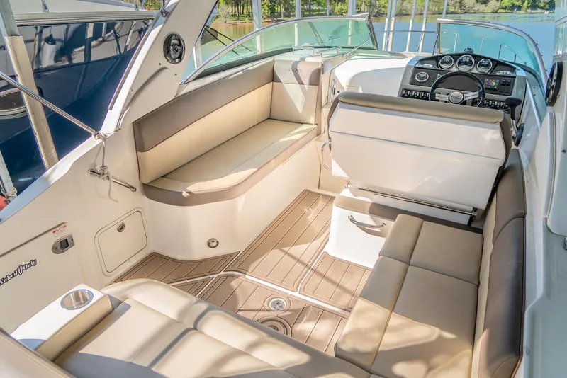 Slide: The Image of 2014 Sea Ray 260 Sundancer interior with beige seating and modern dashboard. - 8